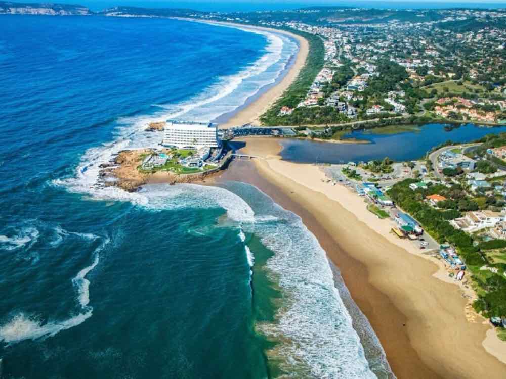 Aerial view of Plettenberg Bay, beach, lagoon and headland hotel.