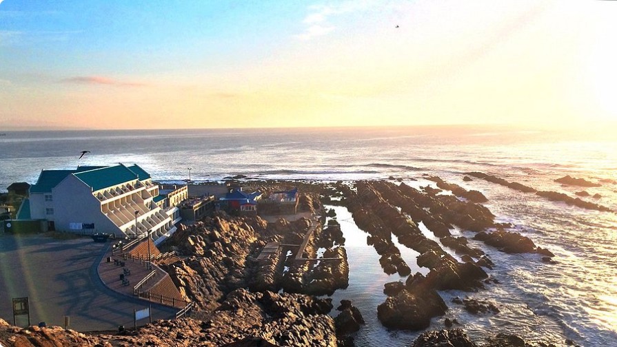 The Point Hotel & Spa, set on the rocks below the lighthouse at Mossel Bay, at sunset.