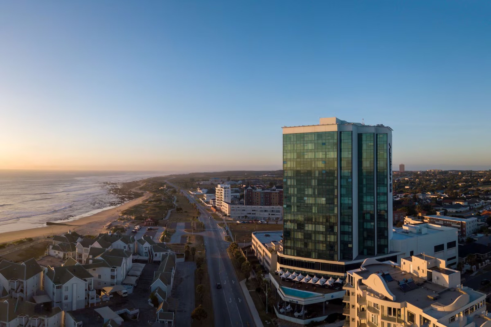 Aerial view of the Radisson Blu Hotel, Port Elizabeth, on the beachfront at sunset.